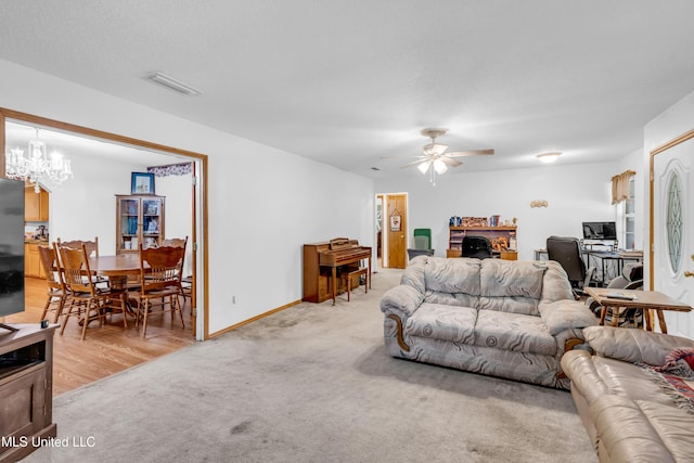 310 John Ave, Pascagoula, MS 39567 - living room with light colored carpet, ceiling fan, a chandelier, a desk, and baseboards