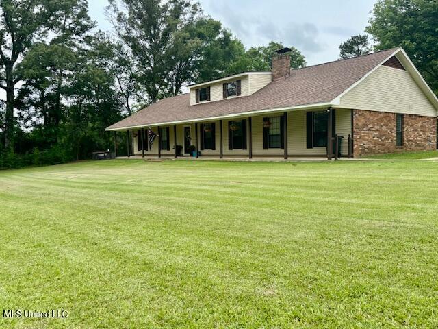 149 Martin Cir, Mendenhall, MS 39114 - farmhouse inspired home featuring a porch, a chimney, a front yard, and a shingled roof