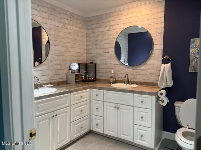 149 Martin Cir, Mendenhall, MS 39114 - full bathroom featuring wooden walls, double vanity, toilet, and tile patterned floors