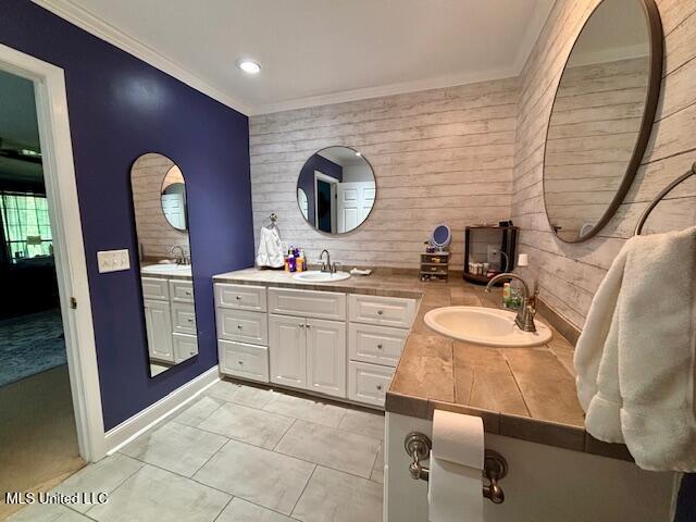 149 Martin Cir, Mendenhall, MS 39114 - bathroom with ornamental molding, double vanity, wooden walls, baseboards, and recessed lighting