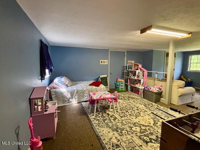 149 Martin Cir, Mendenhall, MS 39114 - bedroom with a textured ceiling and carpet floors