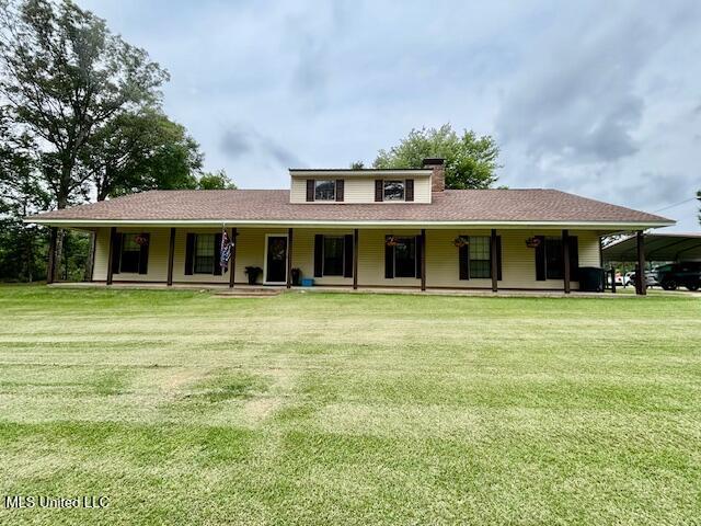 149 Martin Cir, Mendenhall, MS 39114 - rear view of property with covered porch, a yard, and a chimney
