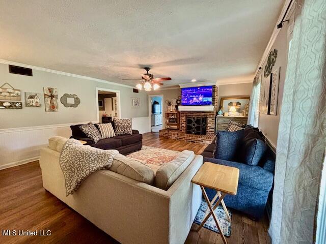 149 Martin Cir, Mendenhall, MS 39114 - living area with ornamental molding, wood finished floors, ceiling fan, and a brick fireplace