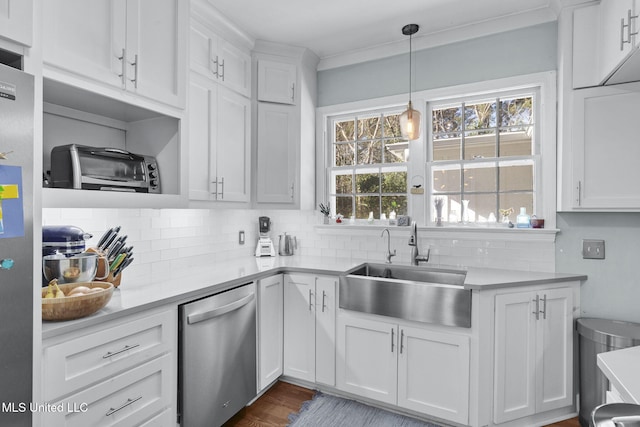 kitchen with appliances with stainless steel finishes, sink, white cabinets, and decorative backsplash