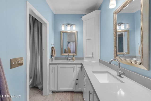 bathroom featuring ornamental molding and vanity