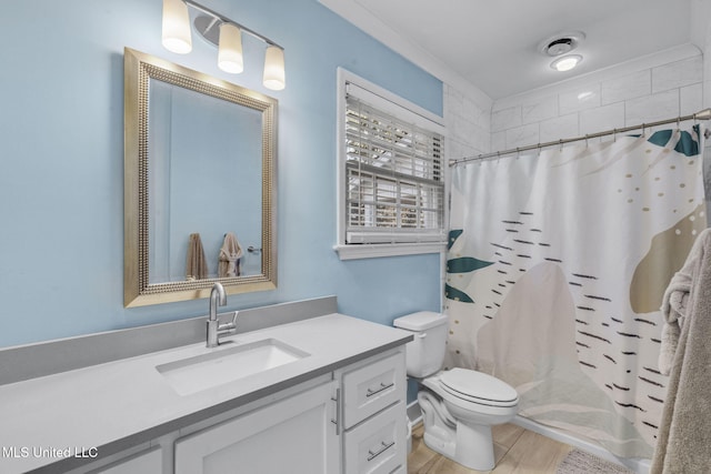 bathroom featuring toilet, a shower with curtain, wood-type flooring, ornamental molding, and vanity