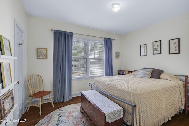 bedroom with dark hardwood / wood-style flooring