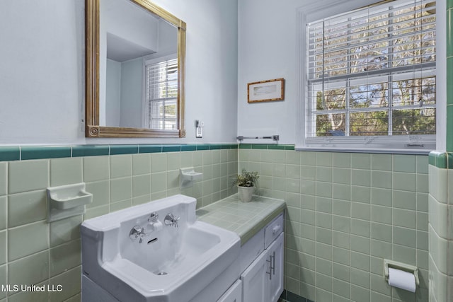 bathroom featuring vanity, tile walls, and a wealth of natural light