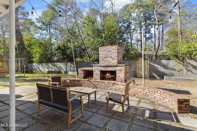 view of patio / terrace with an outdoor brick fireplace