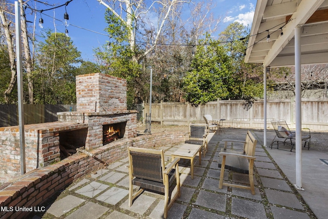 view of patio / terrace featuring an outdoor brick fireplace