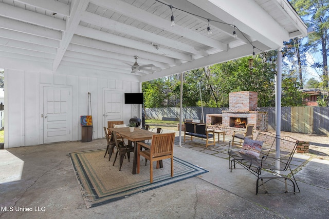 view of patio / terrace featuring an outdoor brick fireplace and ceiling fan