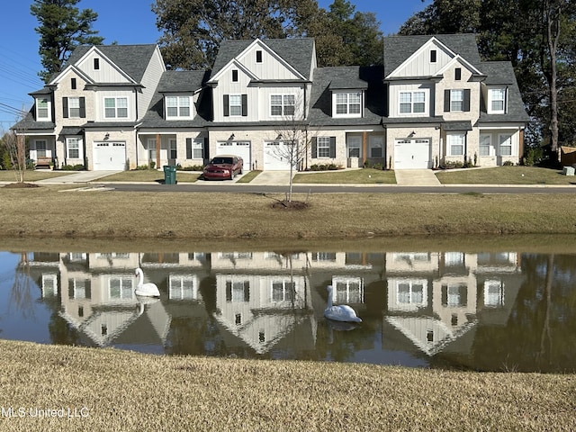 exterior space with a water view and a lawn