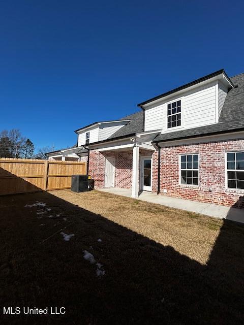 1049 Lexington Lp, Southaven, MS 38671 - back of house featuring central AC, a yard, and a patio