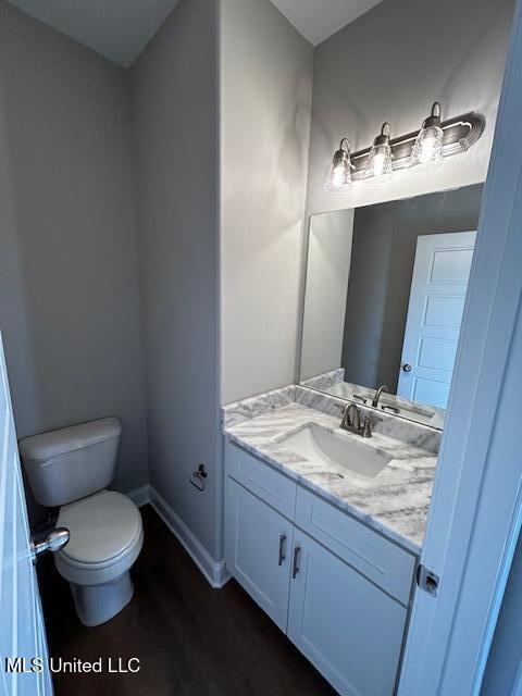 1049 Lexington Lp, Southaven, MS 38671 - bathroom with vanity, toilet, and wood-type flooring