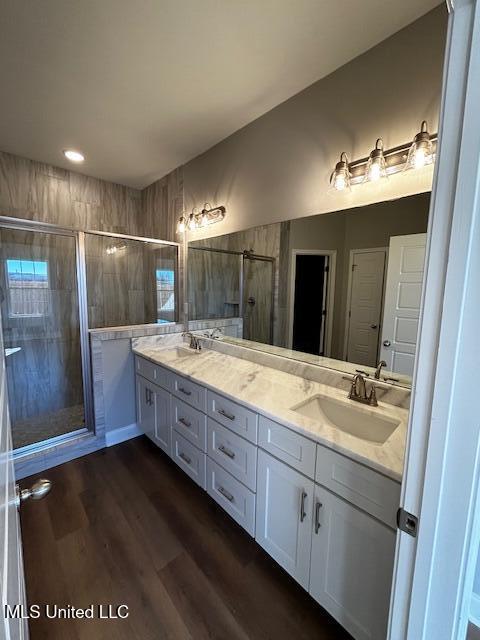 1049 Lexington Lp, Southaven, MS 38671 - bathroom featuring hardwood / wood-style flooring, vanity, and walk in shower