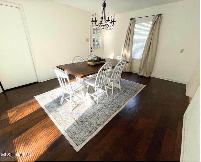 dining space with a chandelier and dark hardwood / wood-style floors