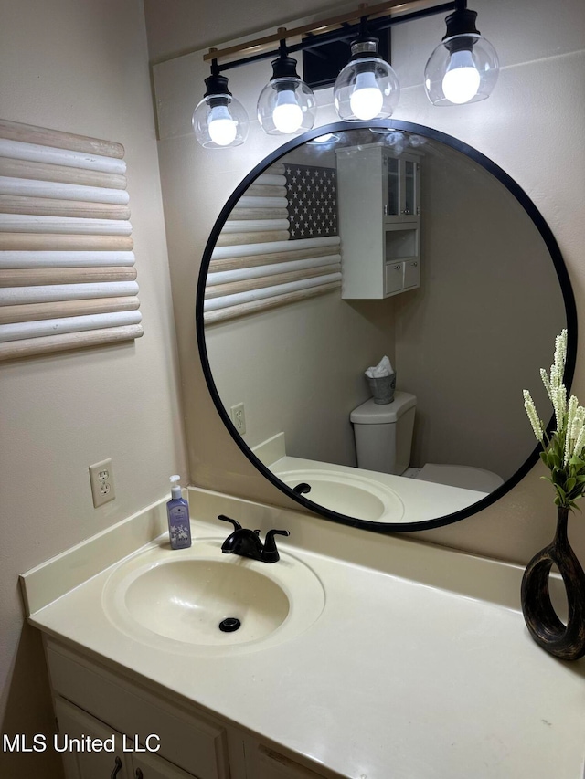 bathroom with vanity and toilet