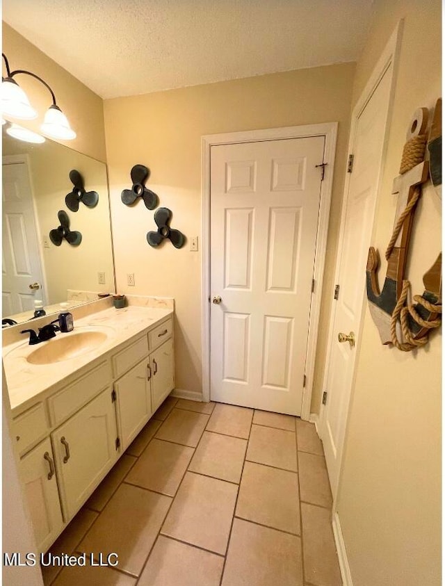 bathroom with vanity, tile patterned floors, and a textured ceiling