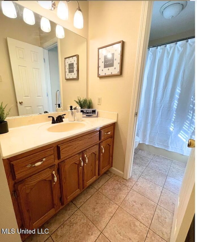 bathroom featuring vanity, tile patterned floors, and a shower with shower curtain