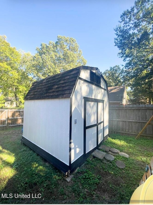 view of outbuilding featuring a lawn