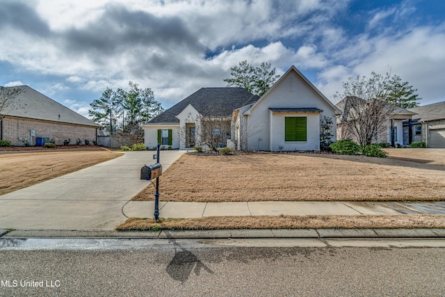 view of front of property featuring a front yard and concrete driveway