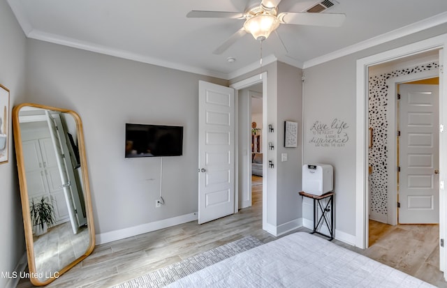 bedroom with light wood-type flooring, baseboards, visible vents, and ornamental molding