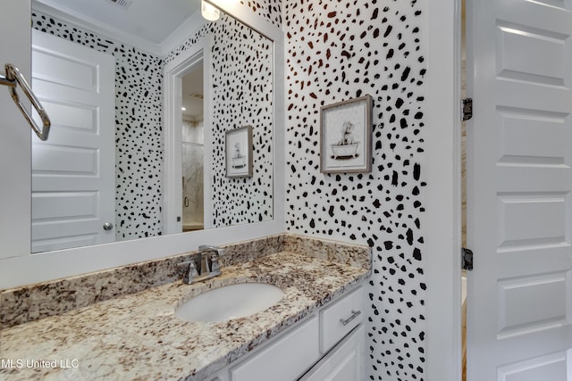 bathroom with a shower and vanity