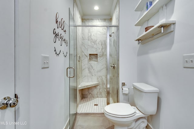 bathroom with a shower stall and toilet