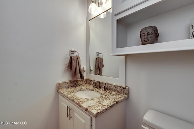 bathroom featuring vanity and toilet