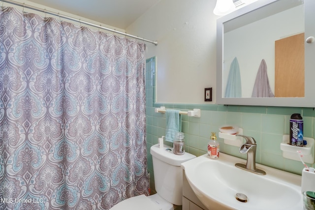 7041 Bosarge Rd, Long Beach, MS 39560 - bathroom featuring toilet, curtained shower, vanity, wainscoting, and tile walls