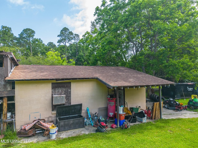 7041 Bosarge Rd, Long Beach, MS 39560 - view of front of home featuring concrete block siding, roof with shingles, and a front yard