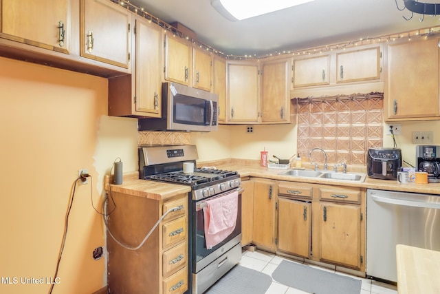 7041 Bosarge Rd, Long Beach, MS 39560 - kitchen with appliances with stainless steel finishes, a sink, light countertops, and tasteful backsplash
