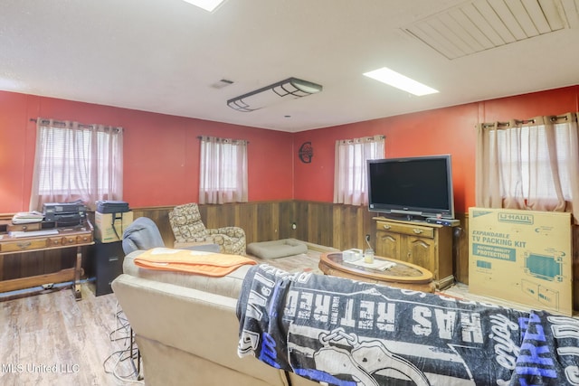 7041 Bosarge Rd, Long Beach, MS 39560 - living room with plenty of natural light, wainscoting, wood finished floors, and wood walls