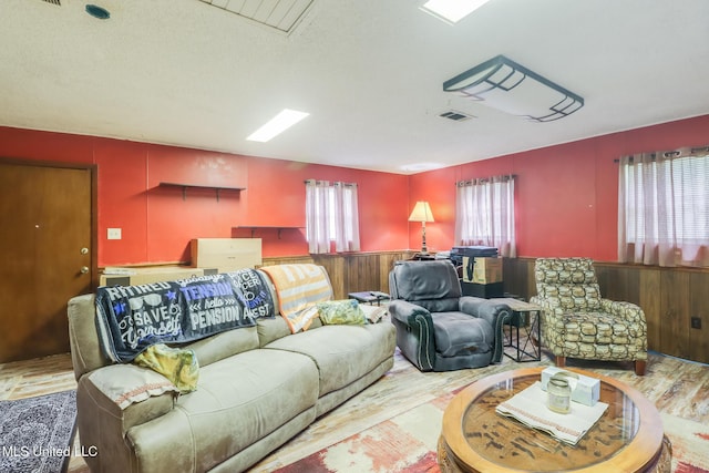 7041 Bosarge Rd, Long Beach, MS 39560 - living area featuring plenty of natural light, wood finished floors, a wainscoted wall, and wooden walls
