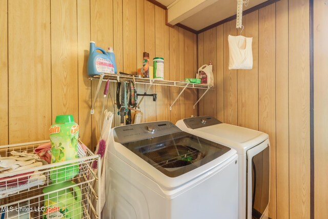 7041 Bosarge Rd, Long Beach, MS 39560 - clothes washing area featuring separate washer and dryer and wood walls