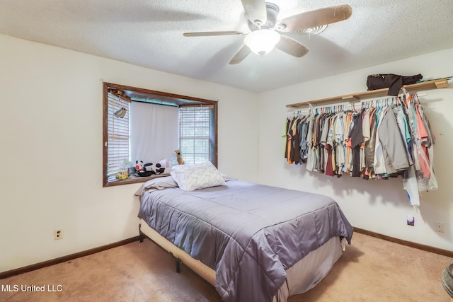 7041 Bosarge Rd, Long Beach, MS 39560 - carpeted bedroom with a textured ceiling, baseboards, a ceiling fan, and a closet