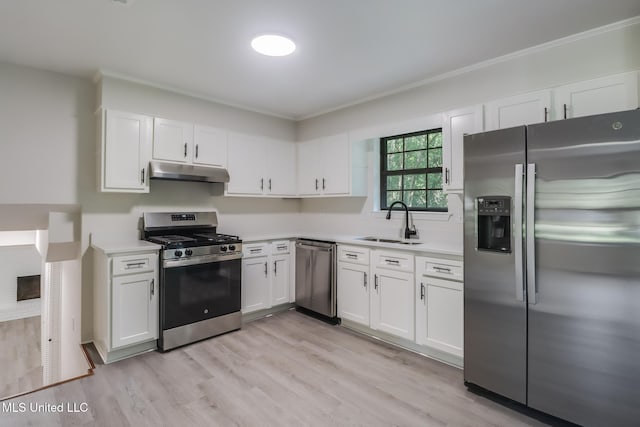 2550 Davidson Rd, Ocean Springs, MS 39564 - kitchen featuring appliances with stainless steel finishes, under cabinet range hood, a sink, light countertops, and crown molding