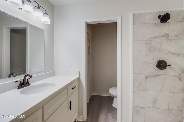 2550 Davidson Rd, Ocean Springs, MS 39564 - bathroom with a tile shower, toilet, vanity, and wood finished floors