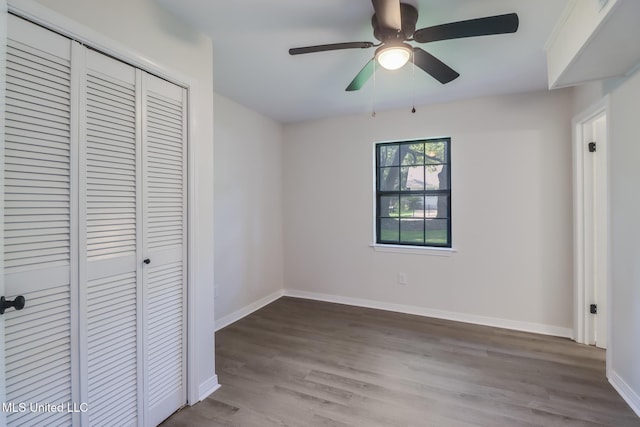 2550 Davidson Rd, Ocean Springs, MS 39564 - unfurnished bedroom featuring a closet, wood finished floors, baseboards, and ceiling fan