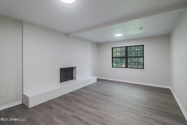 2550 Davidson Rd, Ocean Springs, MS 39564 - unfurnished living room with wood finished floors, a brick fireplace, and baseboards