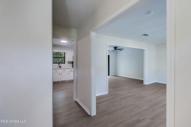 2550 Davidson Rd, Ocean Springs, MS 39564 - hallway featuring wood finished floors, a sink, and baseboards