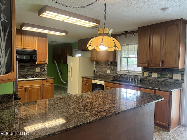 2285 Harkness Ct, Biloxi, MS 39532 - kitchen with a sink, white appliances, backsplash, decorative light fixtures, and a peninsula