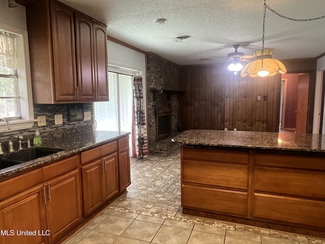 2285 Harkness Ct, Biloxi, MS 39532 - kitchen featuring ceiling fan, a sink, plenty of natural light, backsplash, and wooden walls