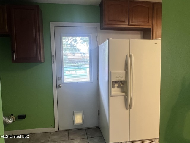 2285 Harkness Ct, Biloxi, MS 39532 - kitchen with white fridge with ice dispenser, light tile patterned floors, and baseboards