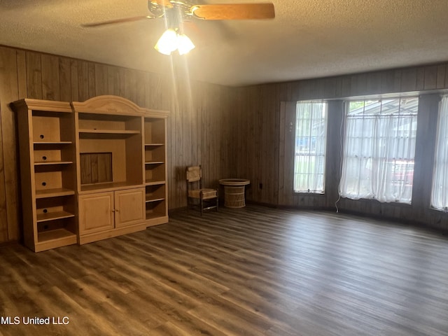 2285 Harkness Ct, Biloxi, MS 39532 - unfurnished living room with a textured ceiling, a ceiling fan, dark wood finished floors, and wooden walls