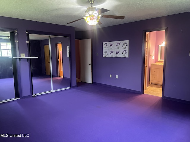 2285 Harkness Ct, Biloxi, MS 39532 - unfurnished bedroom featuring carpet, a textured ceiling, ceiling fan, connected bathroom, and baseboards
