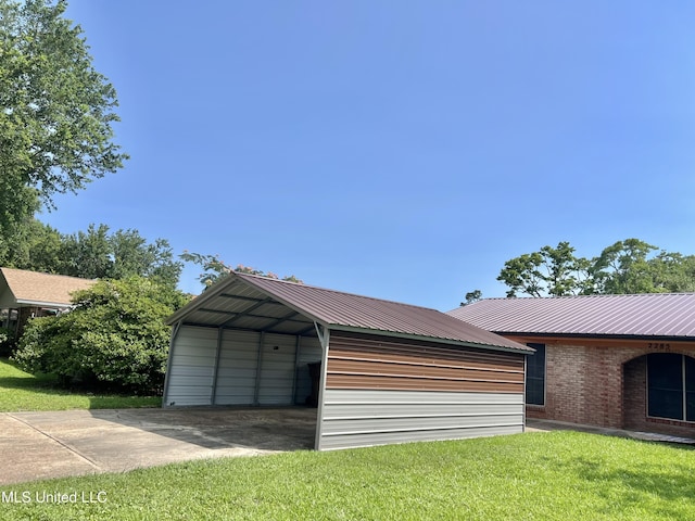 2285 Harkness Ct, Biloxi, MS 39532 - garage featuring a carport and concrete driveway