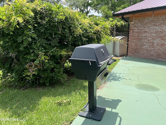 2285 Harkness Ct, Biloxi, MS 39532 - exterior view of brick siding, metal roof, and a downspout