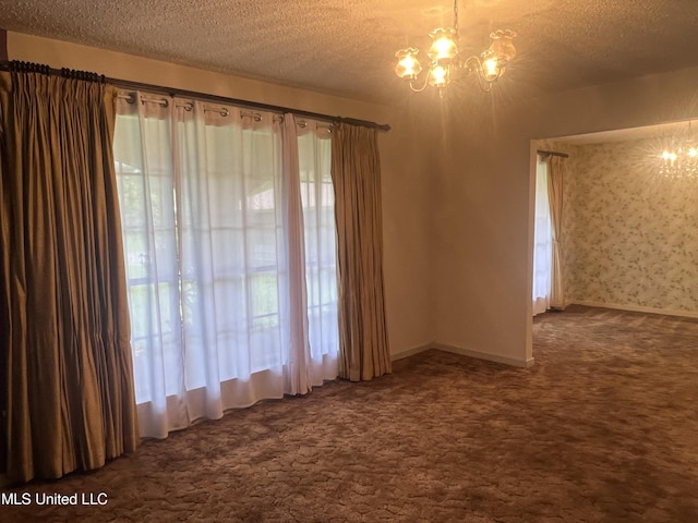 2285 Harkness Ct, Biloxi, MS 39532 - carpeted empty room with a chandelier, a textured ceiling, plenty of natural light, and baseboards
