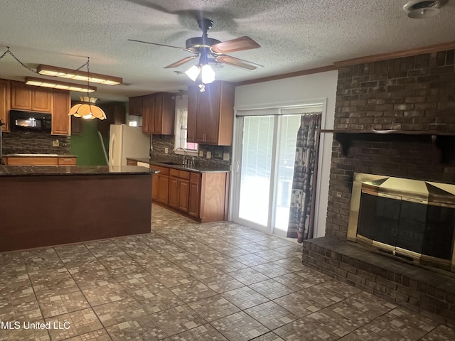 2285 Harkness Ct, Biloxi, MS 39532 - kitchen featuring black microwave, a sink, freestanding refrigerator, dark countertops, and plenty of natural light